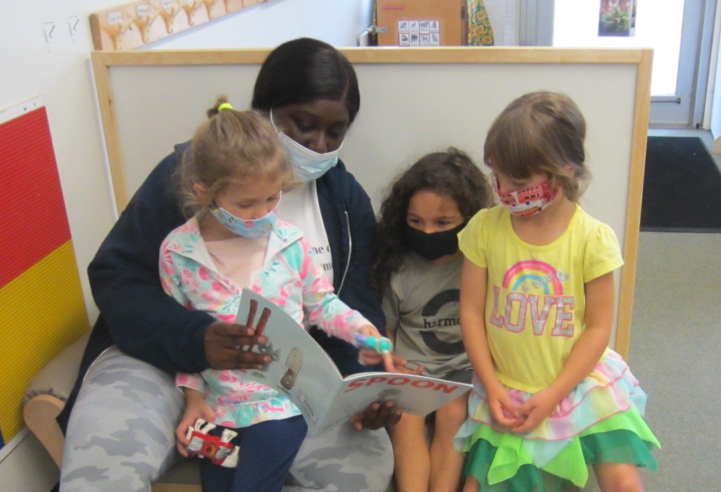 intern reads to child care center kids