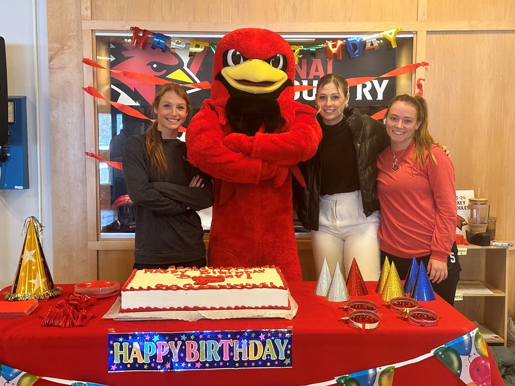 Burghy and Cardnal women hockey players